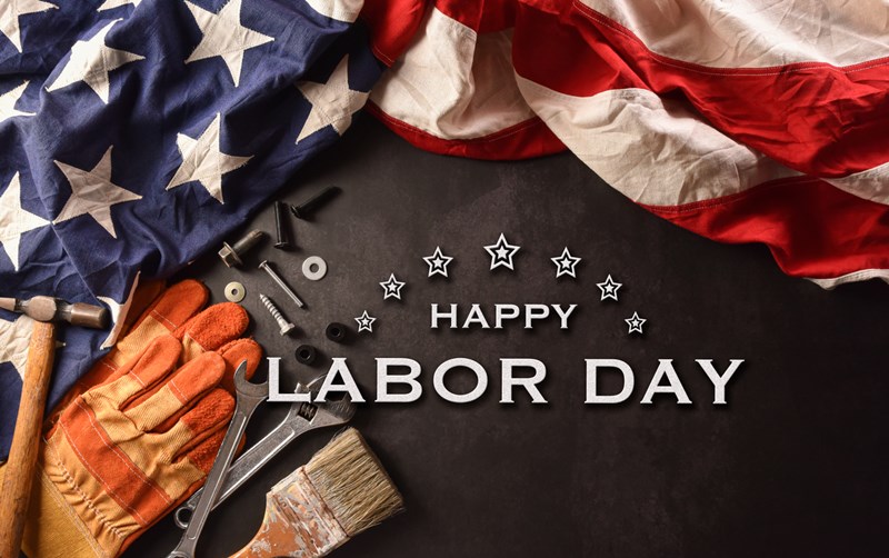 Happy_Labor_day_concept._American_flag_with_different_construction_tools_and_the_text_on_dark_stone_background