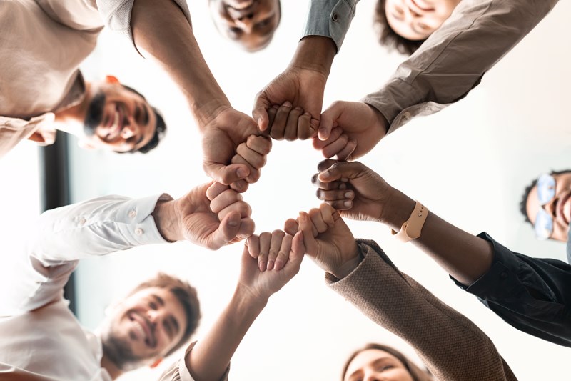 Portrait_of_diverse_business_people_giving_fist_bump_in_cirle