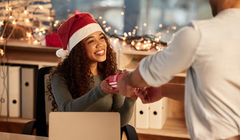 A manager giving a holiday gift to employee